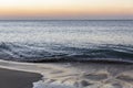 Beautiful orange sunset on the sea with a sandy beach. Magnificent landscape and nature