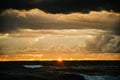 Beautiful orange sunset sky and black sea water in shadow during the summer season at the Baltic sea Royalty Free Stock Photo