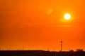 Beautiful orange sunset sky with roof of factory and birds flying near high voltage electric pylons. Evening sunset sky at Royalty Free Stock Photo