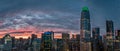 Orange, yellow and red sunset over the San Francisco skyline with a green tip on the tallest building