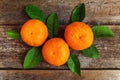 Tangerines with leaves on wooden background Royalty Free Stock Photo