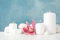 Beautiful orchid candles and spa stones on white table, space for text Royalty Free Stock Photo