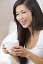 Beautiful Oriental Woman Drinking Tea or Coffee