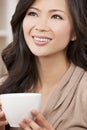 Beautiful Oriental Woman Drinking Tea or Coffee Royalty Free Stock Photo