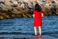 Beautiful oriental women chatting on the seashore with their feet in the water with colorful clothes. here we are at Sottomarina C