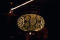 Original oriental lamp shining with warm light during the coming dark
