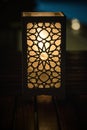 Original oriental lamp shining with warm light during the coming dark