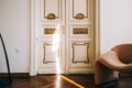 Beautiful ornamental vintage door in bright living room, interior details Royalty Free Stock Photo