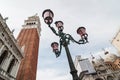 Beautiful ornate lampposts in Piazza San Marco against campanile Royalty Free Stock Photo