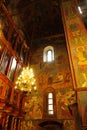 Beautiful ornate painted interior of Orthodox Church. Old frescoes with icons inside luxury Russian cathedral. Moscow Royalty Free Stock Photo