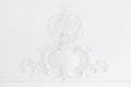 Beautiful ornate white decorative plaster mouldings in studio. The white wall is decorated with exquisite elements of Royalty Free Stock Photo
