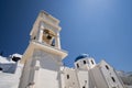 Beautiful orthodox church building with white walls, blue dome and a bell tower in Santorini Royalty Free Stock Photo