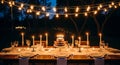 Beautiful Outdoor Dinner Table with Warm String Lights Royalty Free Stock Photo