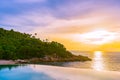 Beautiful outdoor infinity swimming pool in hotel resort with sea ocean view and white cloud blue sky Royalty Free Stock Photo