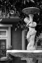 Beautiful outdoor marble fountains,boy holding a vase, vintage style. Black and white tone