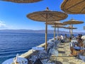 A beautiful outdoor restaurant cafe with a gorgeous view towards the Argosaronic gulf at the picuresque Greek Island of Hydra