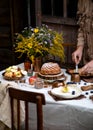 Beautiful outdoor still life in country garden with bundt cake on wooden stand on rustic table Royalty Free Stock Photo