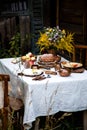 Beautiful outdoor still life in country garden with bundt cake on wooden stand on rustic table Royalty Free Stock Photo