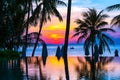 Beautiful outdoor tropical nature landscape of swimming pool in hotel resort with coconut palm tree umbrella and chair nearly sea Royalty Free Stock Photo