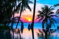 Beautiful outdoor tropical nature landscape of swimming pool in hotel resort with coconut palm tree umbrella and chair nearly sea Royalty Free Stock Photo