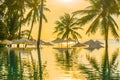 Beautiful outdoor tropical nature landscape of swimming pool in hotel resort with coconut palm tree umbrella and chair nearly sea Royalty Free Stock Photo