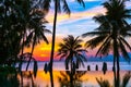 Beautiful outdoor tropical nature landscape of swimming pool in hotel resort with coconut palm tree umbrella and chair nearly sea Royalty Free Stock Photo