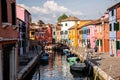 Beautiful outdoor view of boats docked on the canal and colorful buildings on the sides Royalty Free Stock Photo