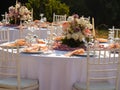 Beautiful outdoor wedding decoration in city. Candles and dried flowers and accessories with bouquets and glasses on Royalty Free Stock Photo