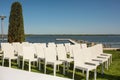 Beautiful outgoing wedding set up.Romantic wedding ceremony , wedding outdoor on the lawn water view. Wedding decor. White wooden Royalty Free Stock Photo