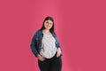 Beautiful overweight woman posing on background. Plus size model