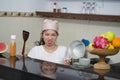Beautiful overwhelmed and stressed Chinese girl working in kitchen unhappy and upset housekeeping - young frustrated Asian woman Royalty Free Stock Photo