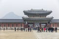 A beautiful pagoda and people walking at the entrance to a popular park in an Asian city. History, religion and architecture.