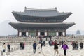 A beautiful pagoda and people walking at the entrance to a popular park in an Asian city. History, religion and architecture.