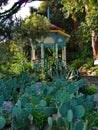 Beautiful painted carved blue and white gazebo among cacti and green trees