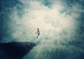 Beautiful painting with a person jumping off a cliff into the clouds. Surreal scene of a boy flying to the light, freedom concept Royalty Free Stock Photo