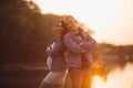 Lovely parents standing near lake and posing together Royalty Free Stock Photo