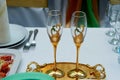 Beautiful pair of wedding goblets with gold . On a tray. Royalty Free Stock Photo