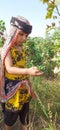 Beautiful Pakistani little girl picking cotton in field with cultural dress green environment Royalty Free Stock Photo