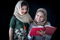 Beautiful Pakistani mother and girl daughter child with hijab reading Quran book, Muslim family, mom and kid read holy Koran book Royalty Free Stock Photo