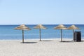 Palm tree sun umbrellas on the beach Royalty Free Stock Photo