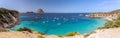 Beautiful Panorama of bay Cala Hort with sea sailing yachts and the mountain Es Vedra. Royalty Free Stock Photo