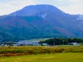 beautiful panorama blue mountain with yellow rice field and light blue sky and fantastic nature Royalty Free Stock Photo