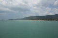 Beautiful panorama day shot of calm blue turquoise ocean water with wild islands, white sand beaches, jungle hills, light blue sky Royalty Free Stock Photo