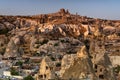 Beautiful landscape of Goreme on sunrise.Cappadocia.Turkey. View of rock formations fairy chimneys, hotels and houses at the cave. Royalty Free Stock Photo