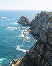 Beautiful panorama of large cliffs with green grass and Atlantic Ocean with tourquoise water