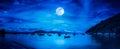 Beautiful panorama nature landscape. Beach by the sea with mountains and full moon at nighttime