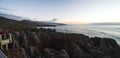 Beautiful panorama of an orange sunset at Pancake Rocks on a sunny winter day in Punakaiki, New Zealand