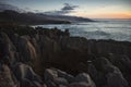 Beautiful panorama of an orange sunset at Pancake Rocks on a sunny winter day in Punakaiki, New Zealand