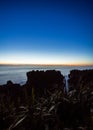 Beautiful panorama of an orange sunset at Pancake Rocks on a sunny winter day in Punakaiki, New Zealand