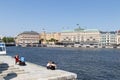 Beautiful panorama promenade in Stogkolm, Sweden. People tourists sit on benches, look at the water on a sunny day